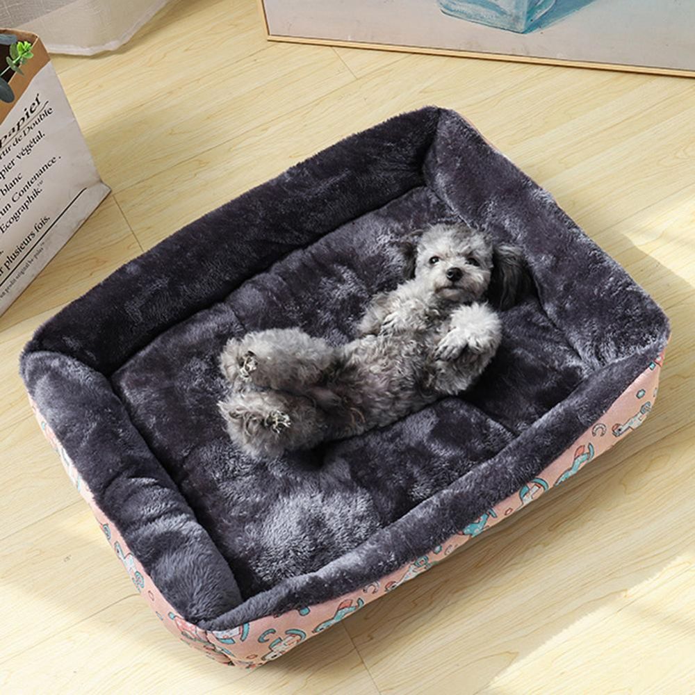 Caniche gris allongé sur le dos dans un panier à chien confortable