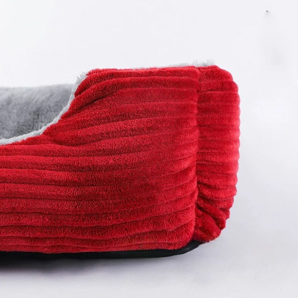 Un grand plan du coin met en évidence le revêtement en velours rouge du panier chien